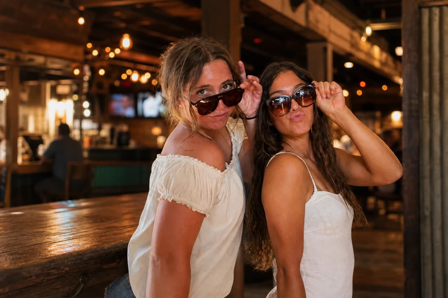 Guests posing at a BuzzyBooth inside Hurricanes Bar and Grill