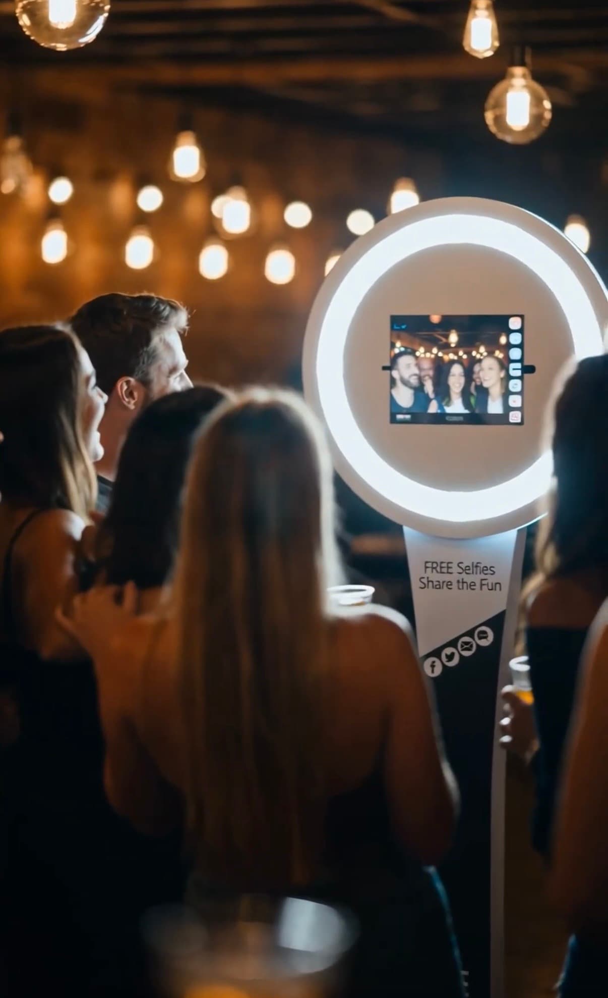 Guests taking a photo together at a real BuzzyBooth in a restaurant