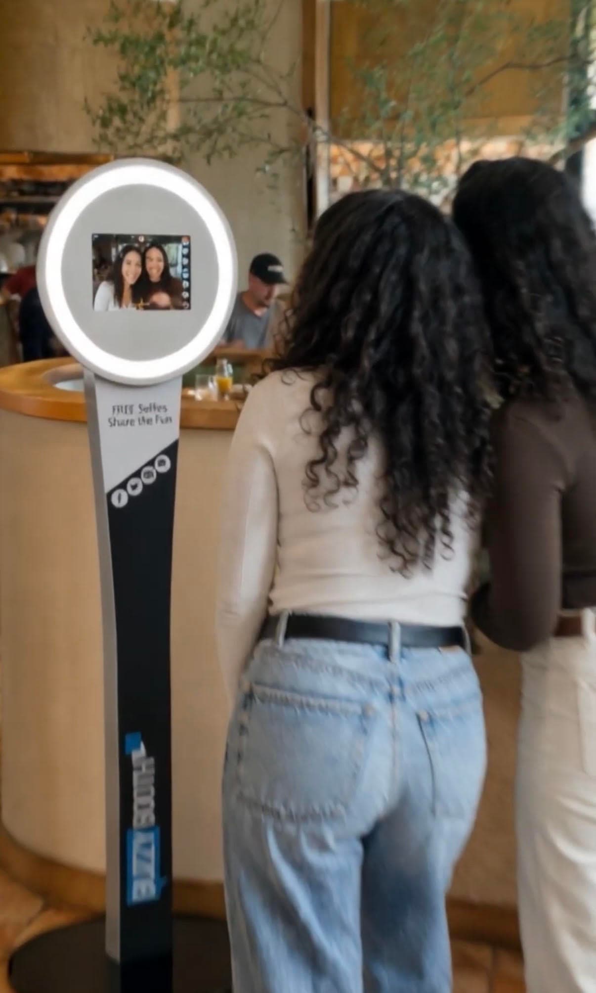 Restaurant photo booth with guests creating branded photos
